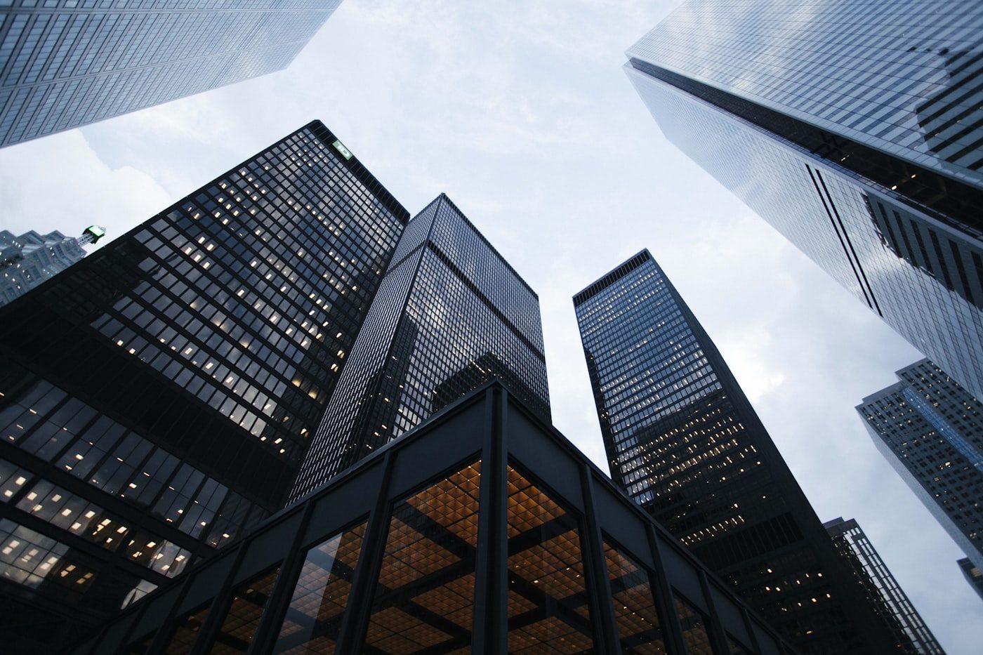 Corporate glass towers seen from below against the sky
